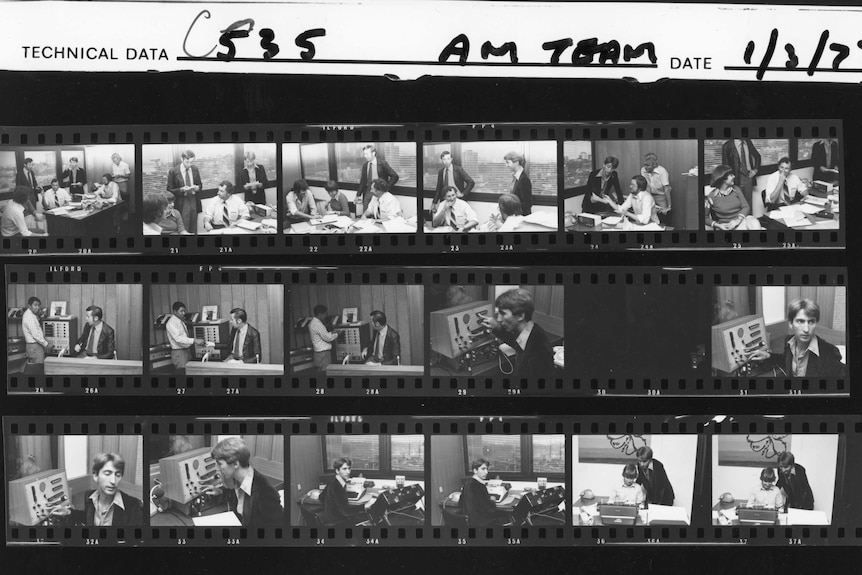 Archival proof sheet of photos of the AM team with various staff in a William Street office.