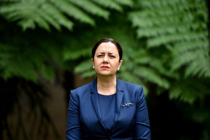 Annastacia Palaszczuk with a serious expression in a suit at parliament