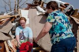 Women search through debris after Harrisburg tornado.