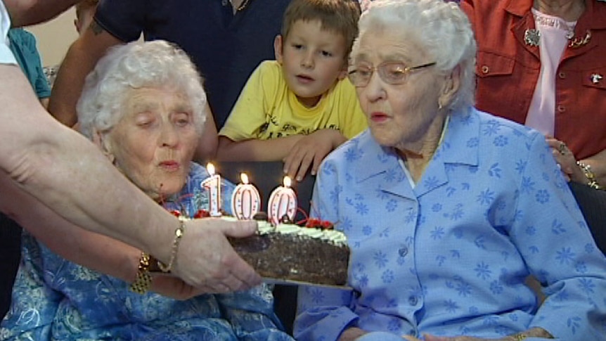 100 year old twins blow out candles