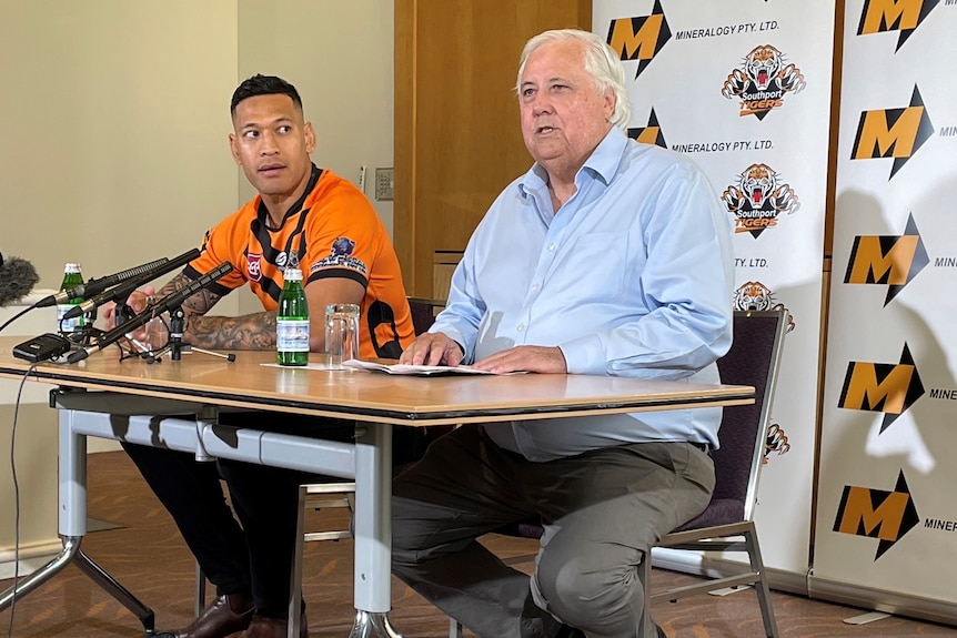 Two men sitting next to one another during a press conference