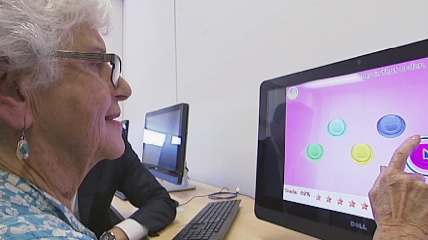 An elderly person using a computer.