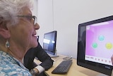 An elderly person does brain training exercises.