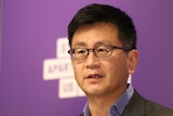 Victorian Deputy Chief Health Officer Allen Cheng, who has short dark hair and glasses, at a press conference.