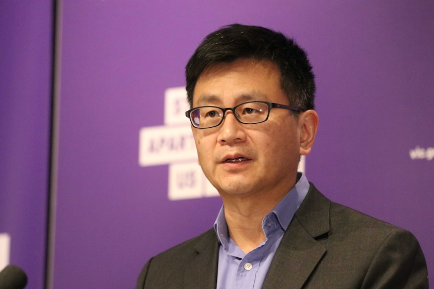 Victorian Deputy Chief Health Officer Allen Cheng, who has short dark hair and glasses, at a press conference.