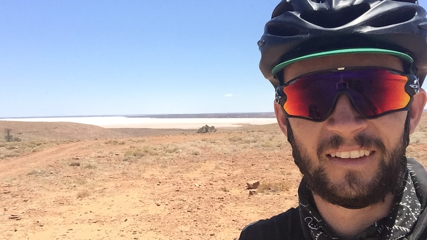 Sean Whelan stops for a break on his ride through central Australia.