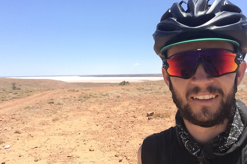 Sean Whelan stops for a break on his ride through central Australia.