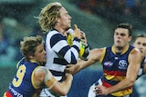 Rory Sloane of the Crows tackles Cameron Guthrie of the Cats