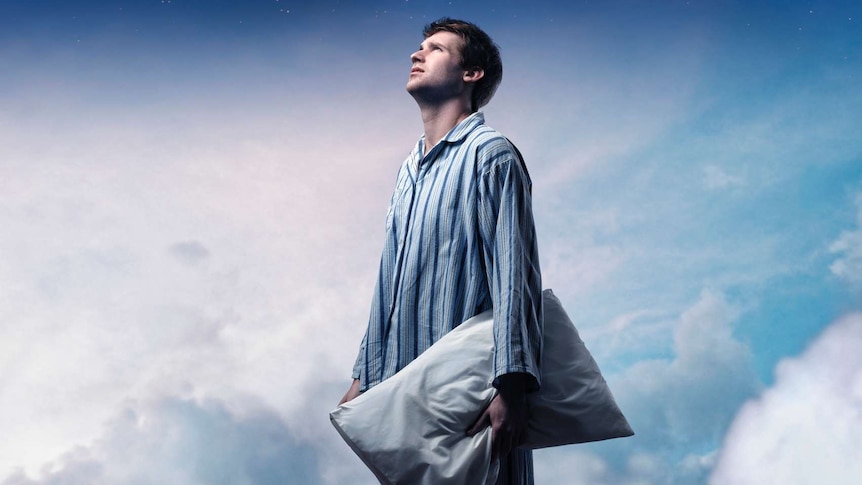 man in pyjamas surrounded by clouds and night sky