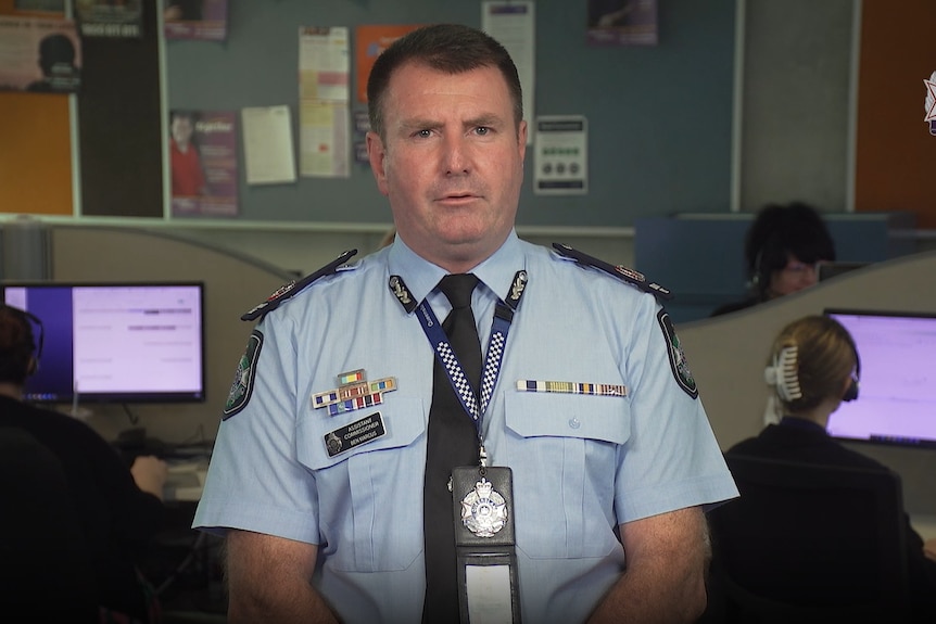Ben Marcus in uniform speaks into the camera from the middle of an operations centre