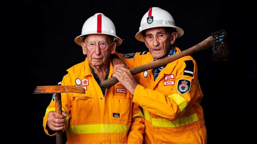 Bilpin Rural Fire Service members Albert Newtown and Bill Johnson stand in their fire gear.