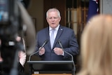 Prime Minister Scott Morrison speaking at a lectern in the Prime Minister's courtyard