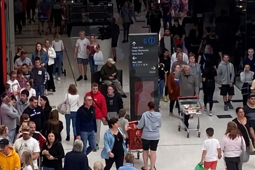 Crowds make their way through a shopping centre at close distance