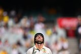Australia batter Mitch Marsh looks to the sky while walking off the MCG after being dismissed for 96.