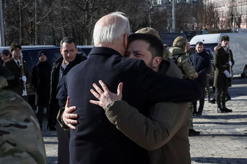 Biden and Zelenskyy embrace in a tight hug outside in Kyiv