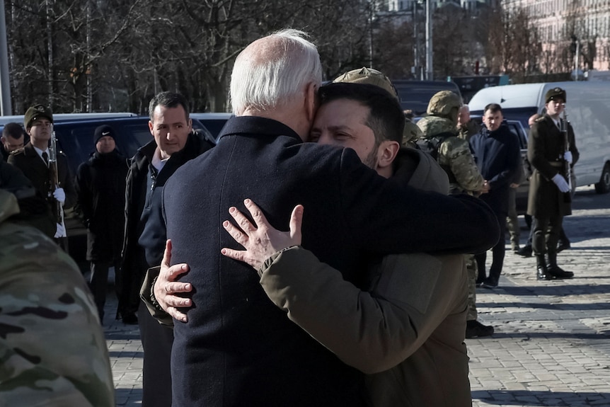 Biden and Zelenskyy embrace in a tight hug outside in Kyiv