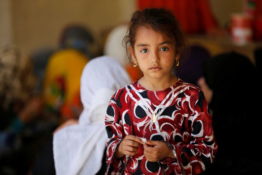 A young Iraqi girl looking solemn