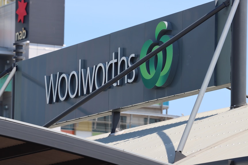 A photo of a Woolworths sign on the roof of a supermarket.