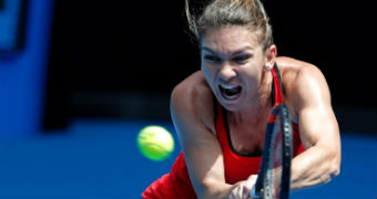 Simona Halep stretches to play a double-fisted backhand against Lauren Davis at the Australian Open.