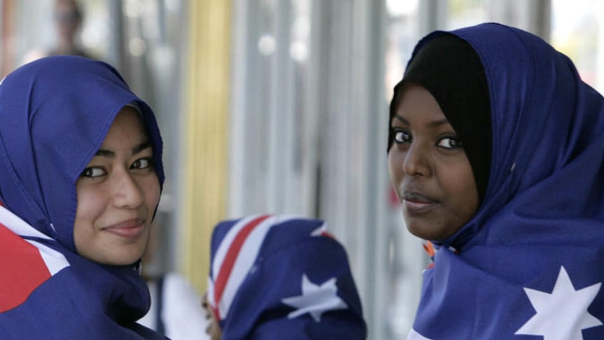 Two young Muslim women wear Australian flag hijabs.