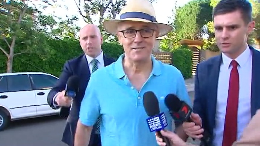 Malcolm Turnbull in a hat and polo shirt