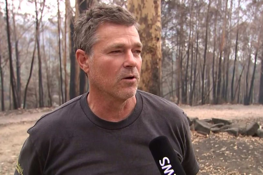 A man standing in bushland