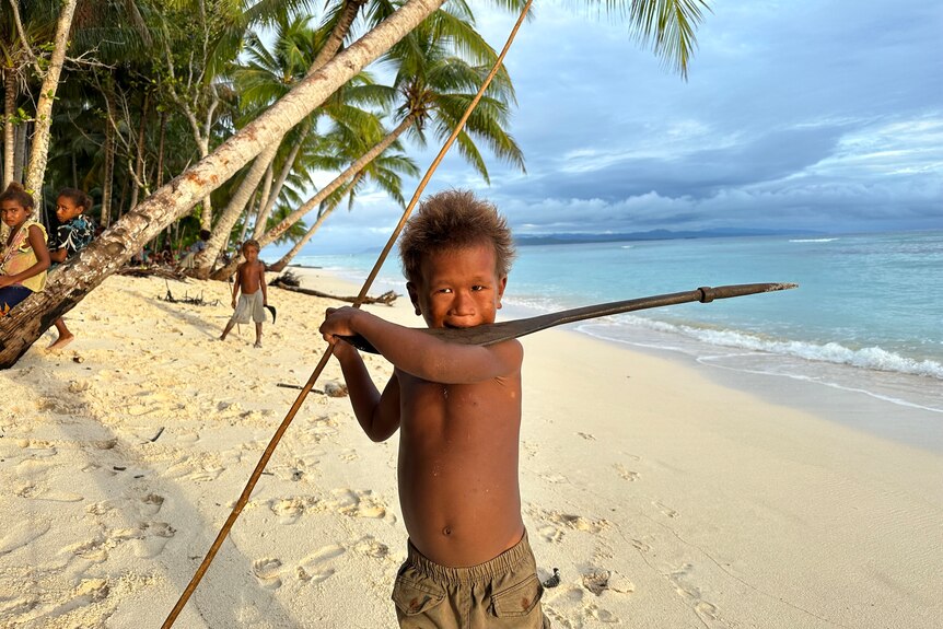 young boy with spear