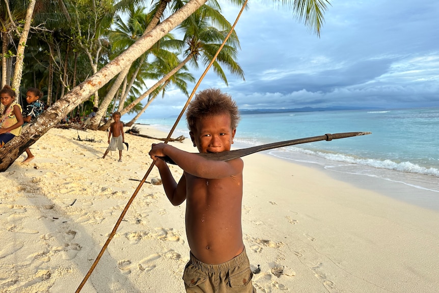 young boy with spear