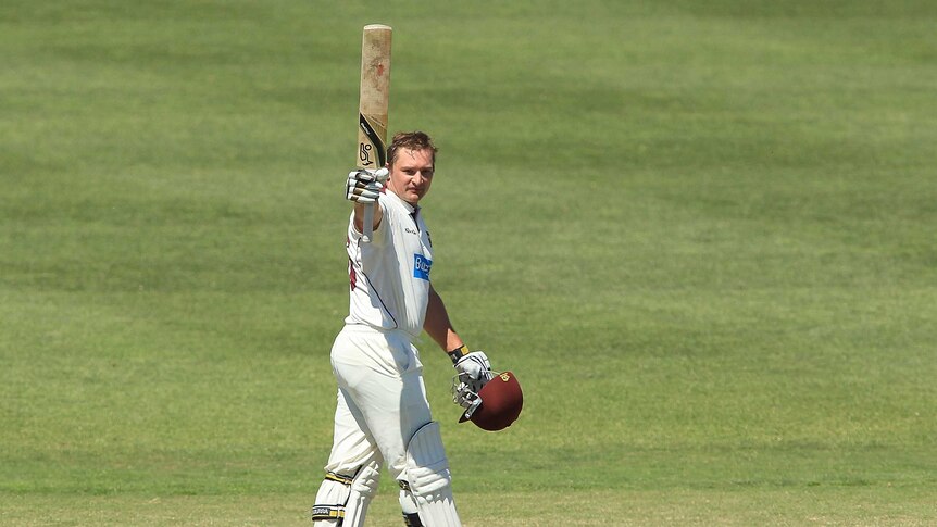 Queensland's Peter Forrest celebrates after reaching his Shield century against South Australia.