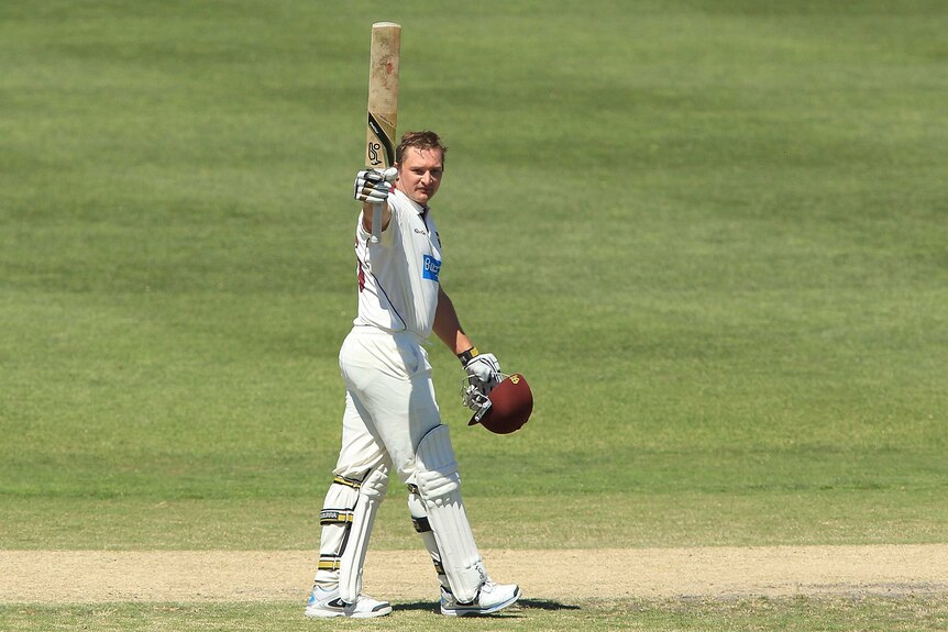 Queensland's Peter Forrest celebrates after reaching his Shield century against South Australia.