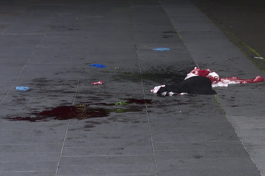 Clothing with blood on it on the ground.