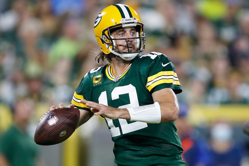 Aaron Rodgers prepares to throw an American football