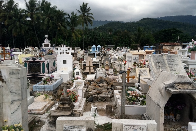 A graveyard with the mountains in the background