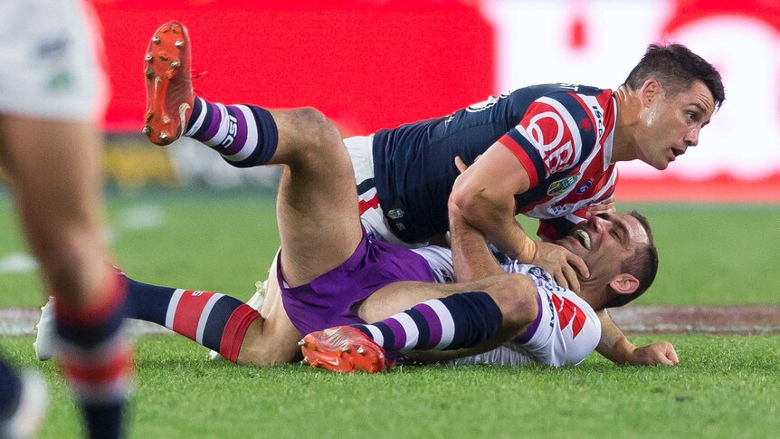Cameron Smith and Cooper Cronk on the ground during the NRL grand final.
