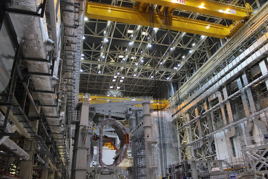 The towering multi-level assembly hall as seen from inside with one D-shaped segment suspended at the far end