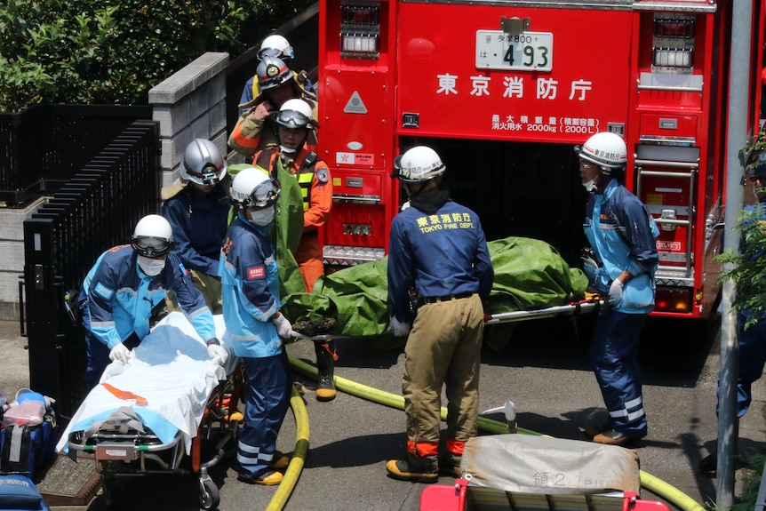 Rescue workers carry a victim