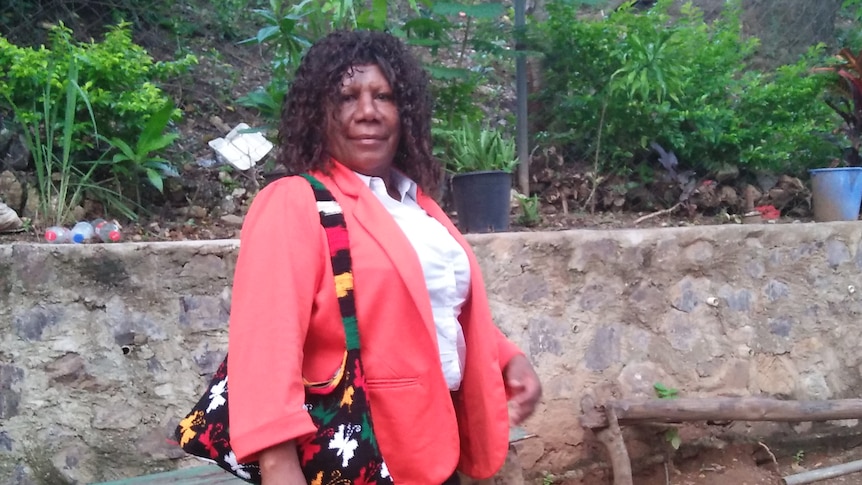 Woman in a red jacket smiles at the camera