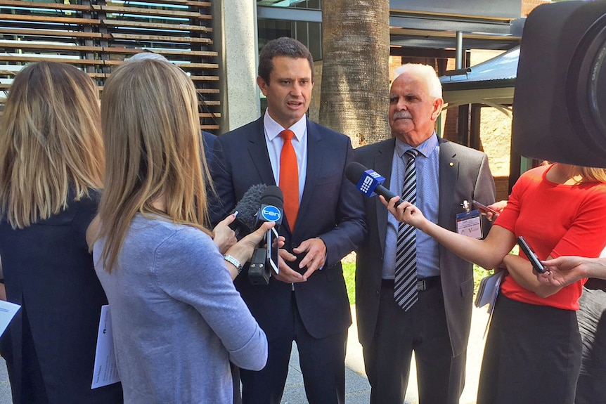 Government minister Kyam Maher with Frank Lampard at a news conference