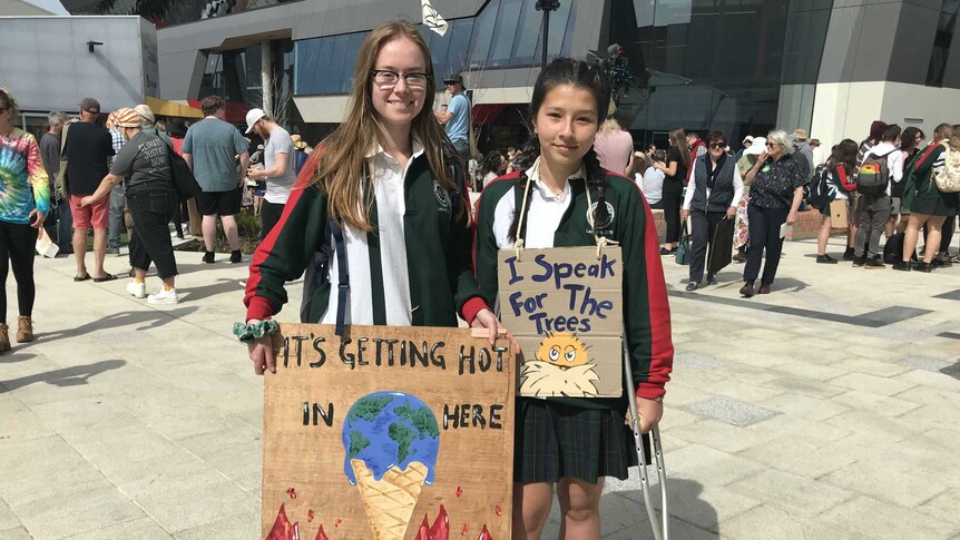 Ruby (L) and Sian (R) from Devonport attend a climate change rally. 20 September 2019.