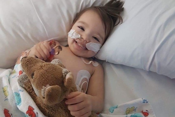 Eli Vale in hospital holding a teddy bear