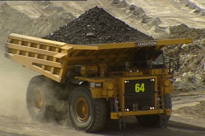 Generic TV still of coal truck driving at Qld mine