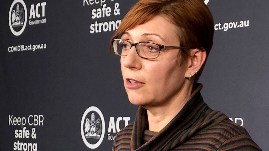 Rachel speaks from a lectern during a press conference.