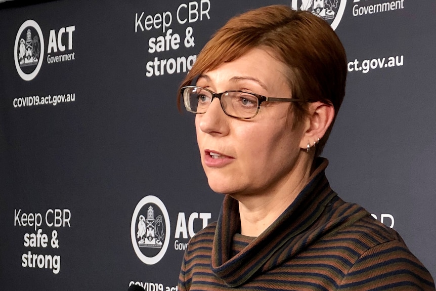 Rachel speaks from a lectern during a press conference.