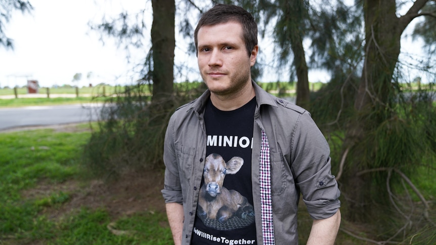 A man standing in front of trees