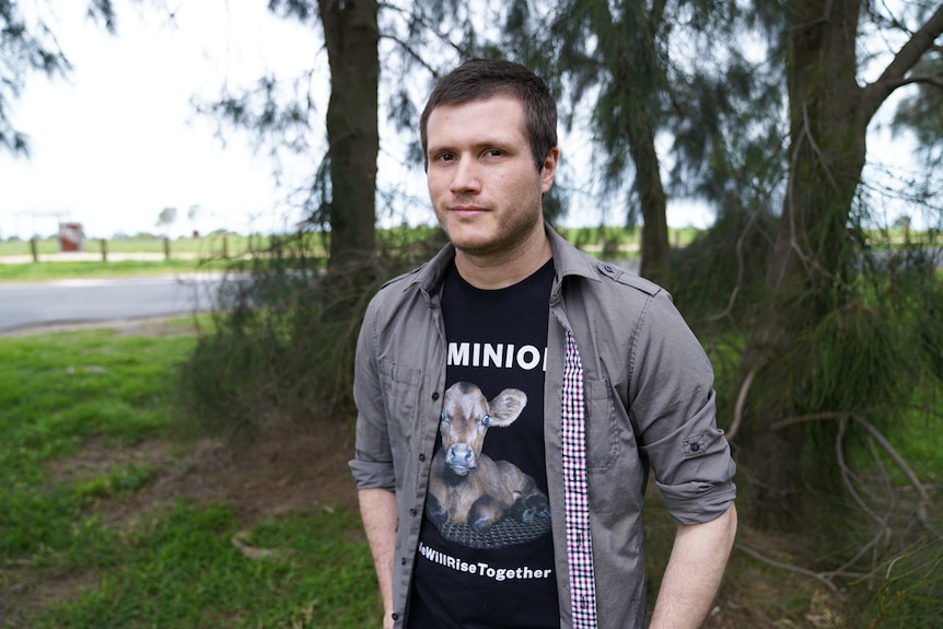 A man standing in front of trees