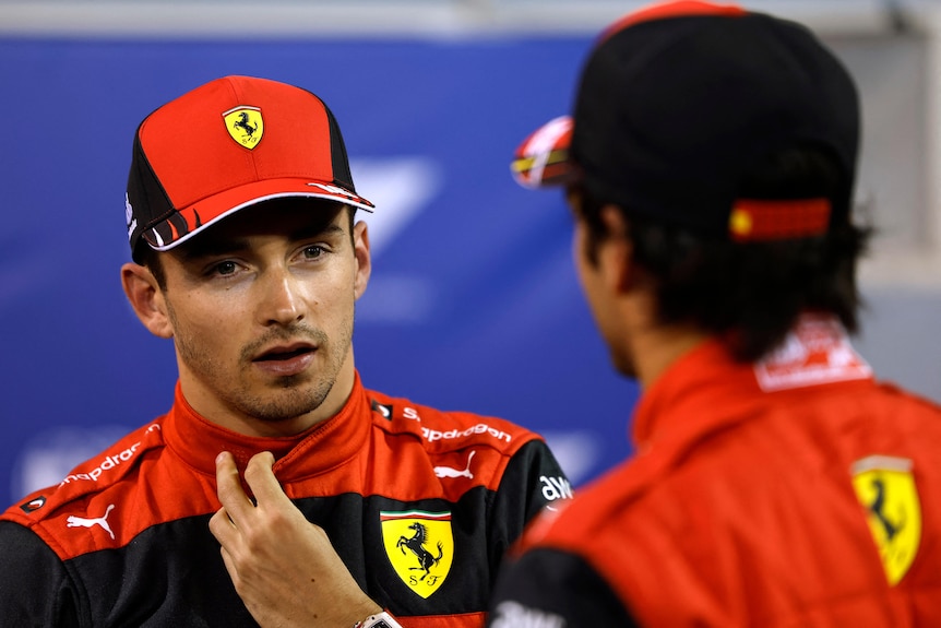 Two racing teamates speaking after a qualifying session.