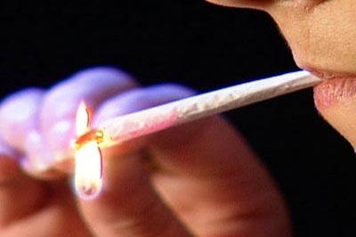 Woman lights a joint (ABC-TV)
