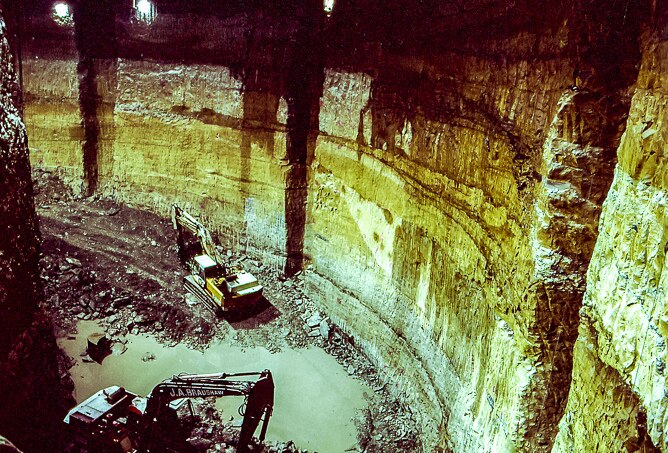 Construction machinery at the bottom of a sandstone hole