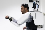A composite of a paralysed man donning an exoskeleton learning to walk