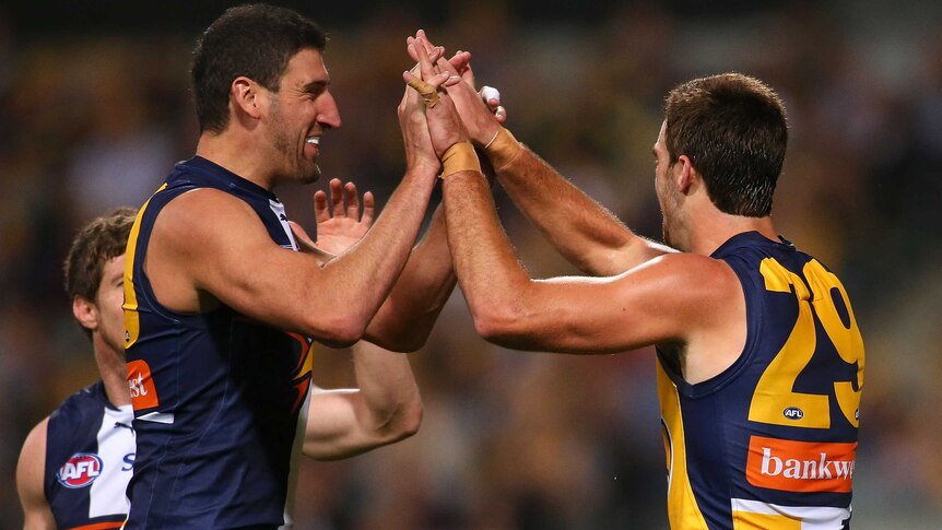 Dean Cox and Scott Lycett celebrate a goal for West Coast against Melbourne